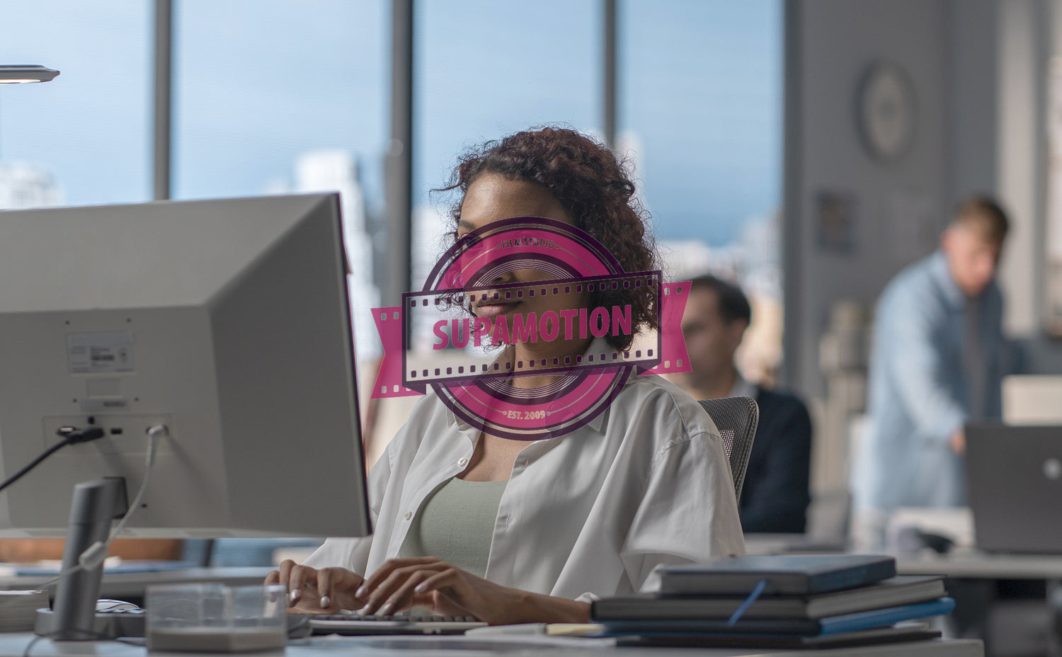 African American female employee working at her desk in a modern office