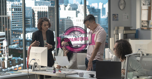 Diverse team of employees brainstorming, gathering around the computer screen