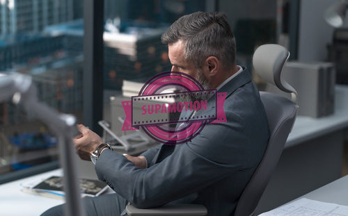 Portrait of 50s Caucasian businessman looking out of the window of his office