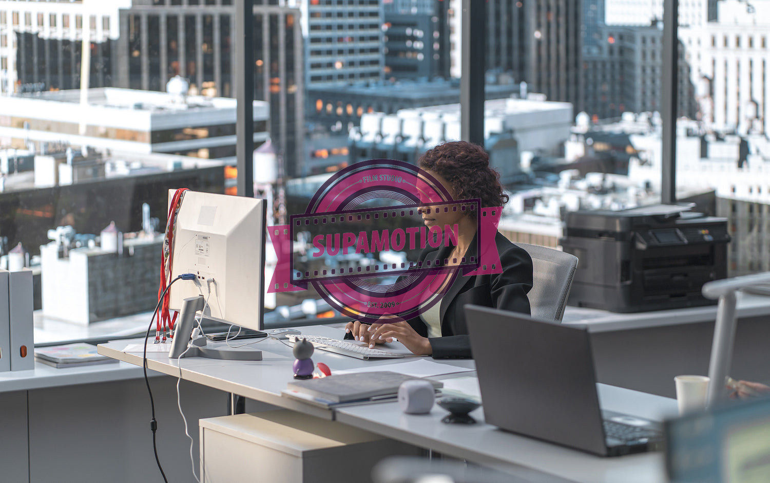 African American female employee working at her desk in a modern office