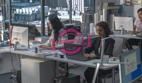 Diverse female employees working at thir desks in a modern office