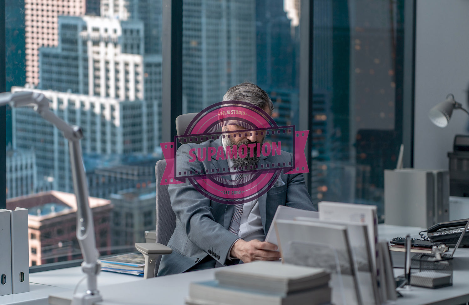 Portrait of 50s adult Caucasian businessman working at his desk in the office