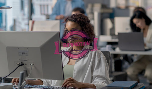 African American female employee working at her desk in a modern office