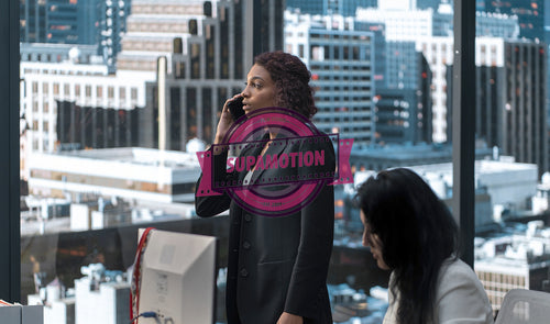 African American female employee having a phone call in a modern office
