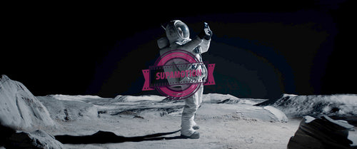Male actor in astronaut suit making selfie on a Moon shooting set