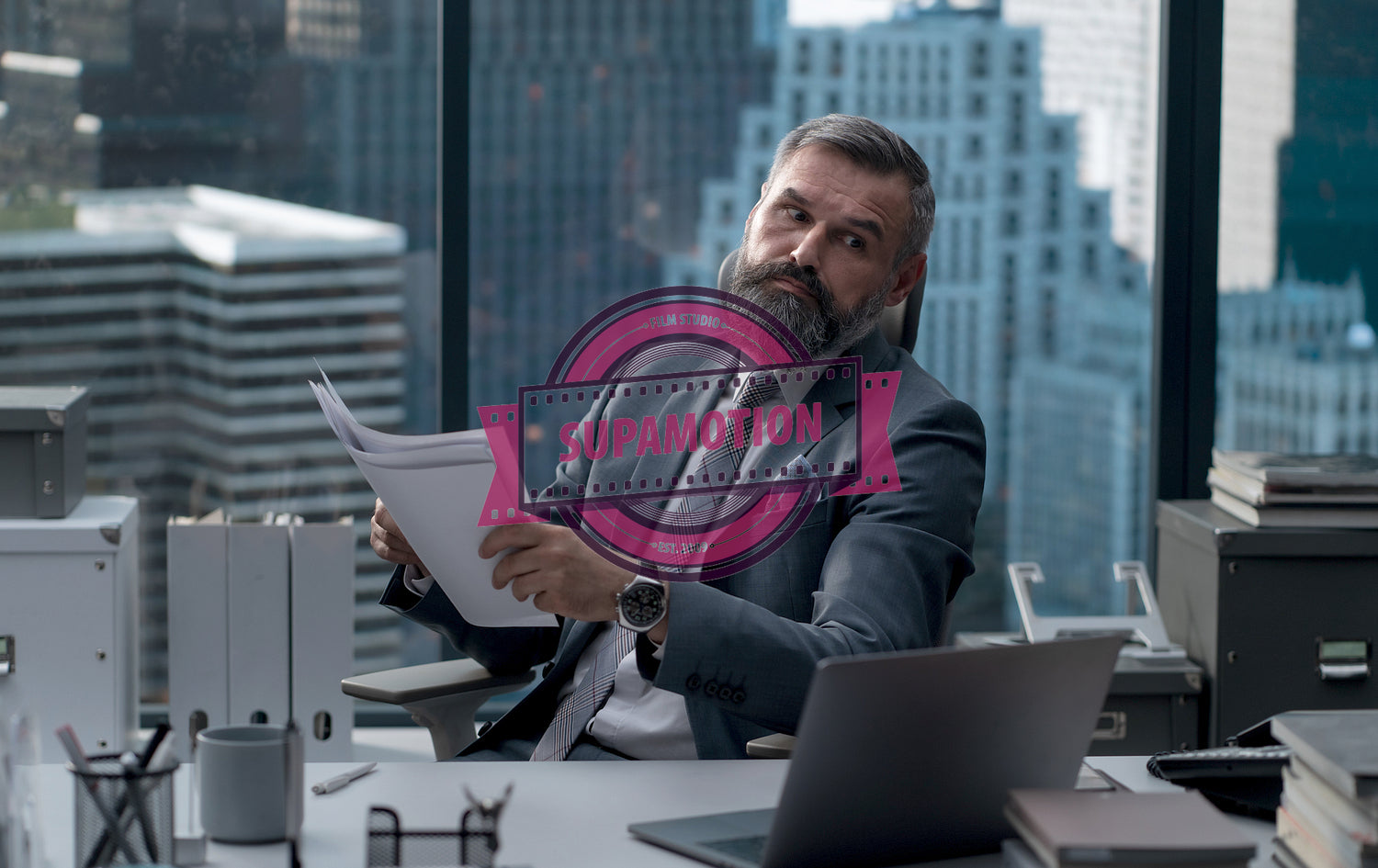 Portrait of 50s adult Caucasian businessman working at his desk in the office