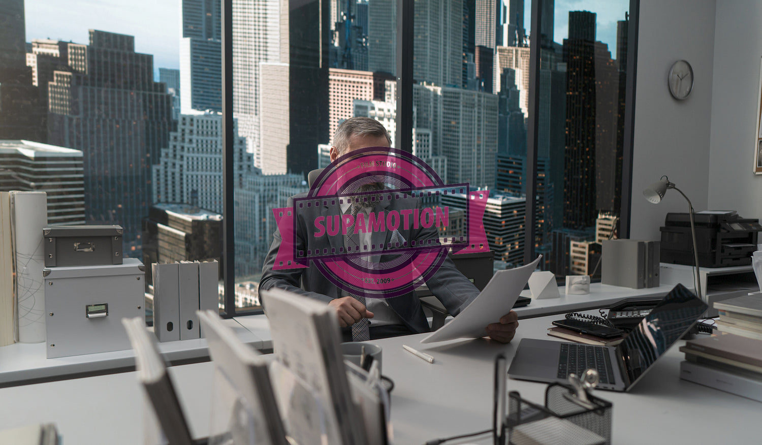 Portrait of 50s adult Caucasian businessman signing documents in his office 