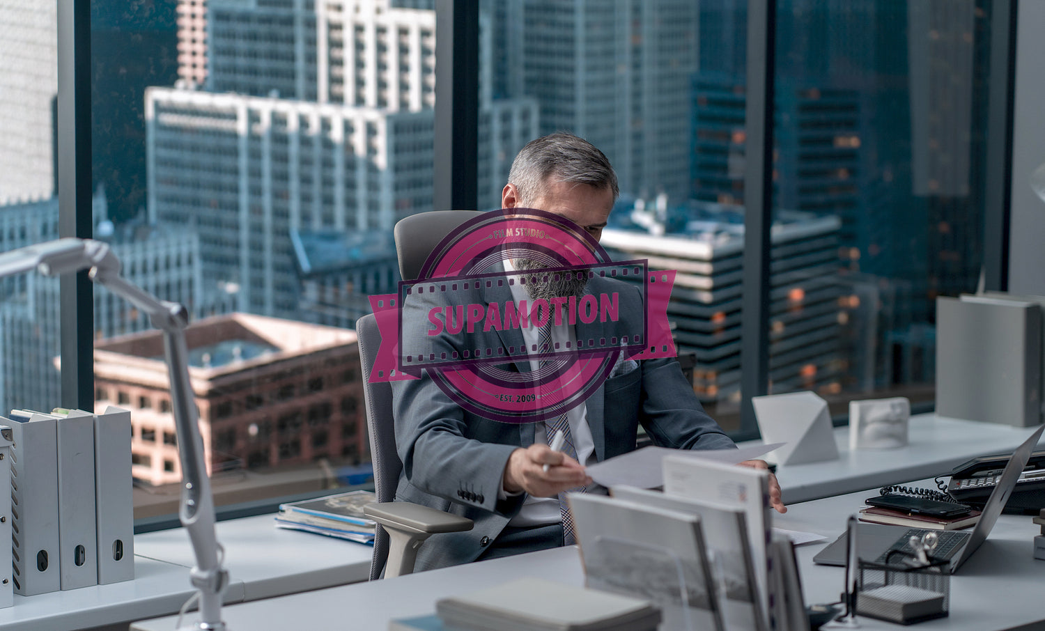 Portrait of 50s adult Caucasian businessman working at his desk in the office