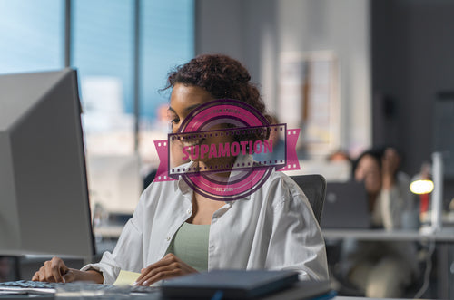 African American female employee working at her desk in a modern office