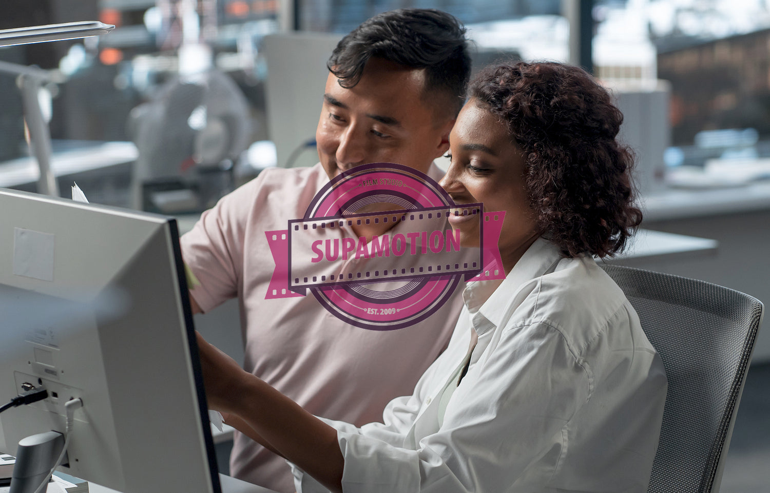 Diverse team of employees brainstorming, gathering around the computer screen