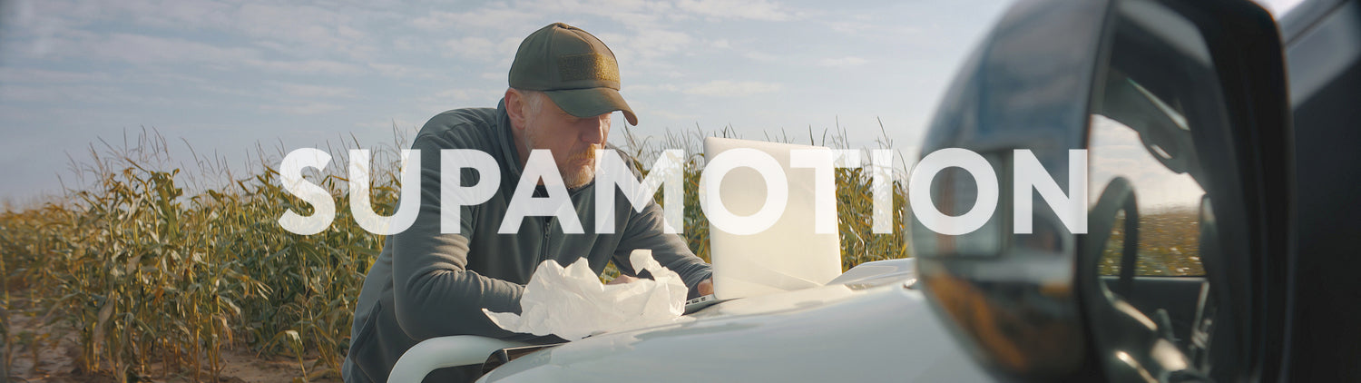 Caucasian male farmer checking his laptop and having a meal early in the morning