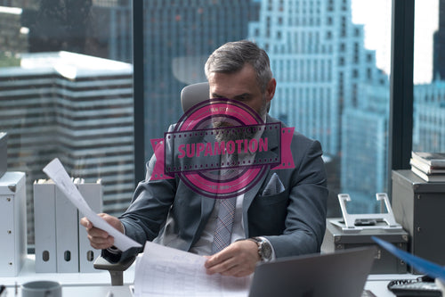 Portrait of 50s adult Caucasian businessman working at his desk in the office