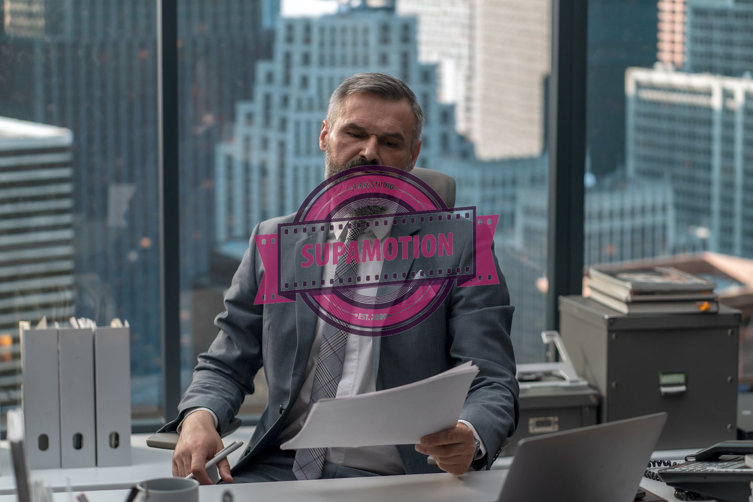 Portrait of 50s adult Caucasian businessman working at his desk in the office