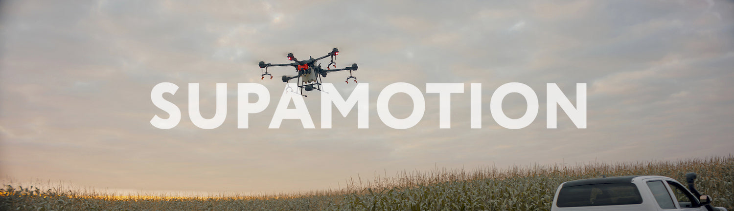 Huge intelligent agriculture drone with spray nozzles flying against sky