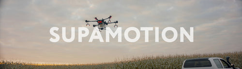 Huge intelligent agriculture drone with spray nozzles flying against sky
