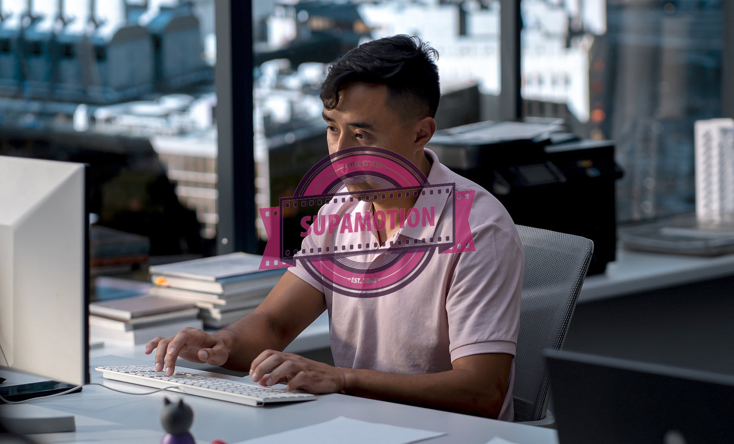 Middle Eastern male employee working at his desk in a modern office