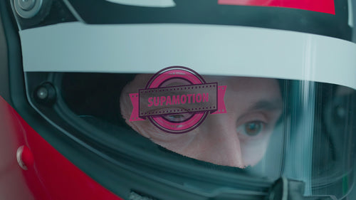 ECU Portrait of sports car driver in protective helmet racing on a speedway