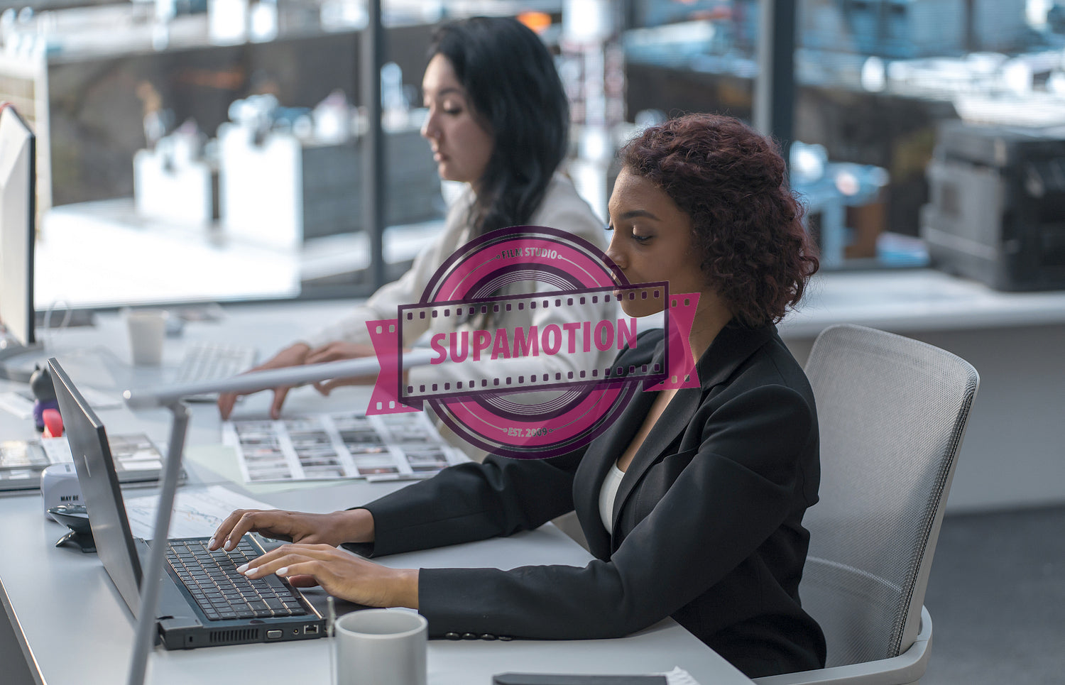 Diverse female employees working at thir desks in a modern office